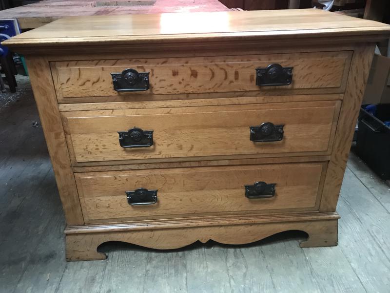 Arts and crafts oak chest of drawers .