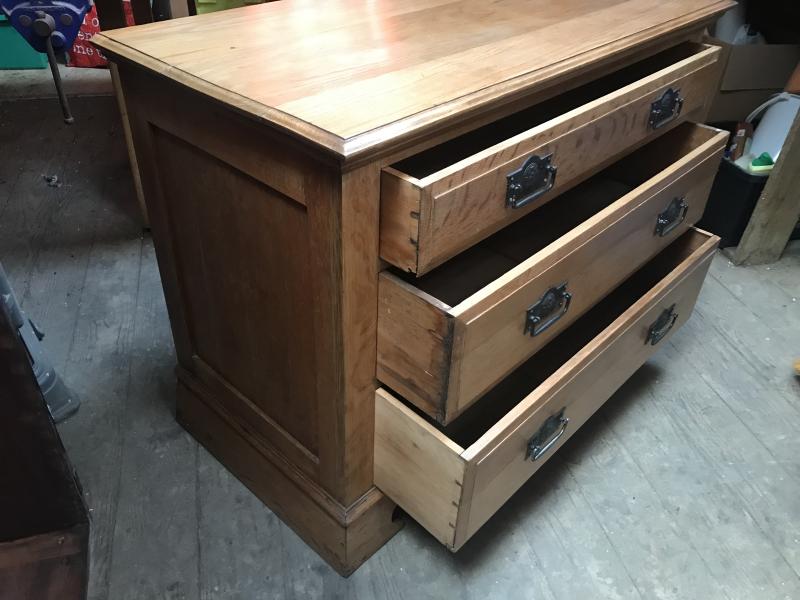 Arts and crafts oak chest of drawers .