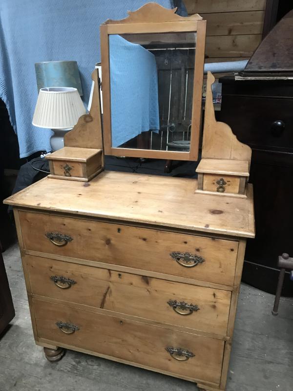 Victorian pine chest of drawers with ornate mirror.