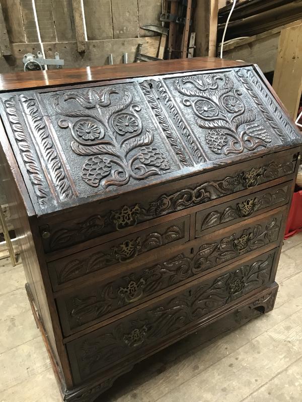 Early 19th century carved oak bureau.